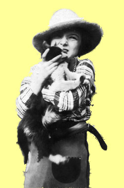 Nancy in cowboy suit holding cat